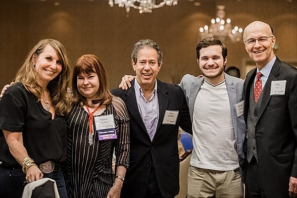 Group of friends smiling at event.