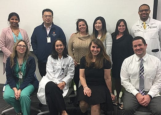 Diverse healthcare professionals posing for a group photo.