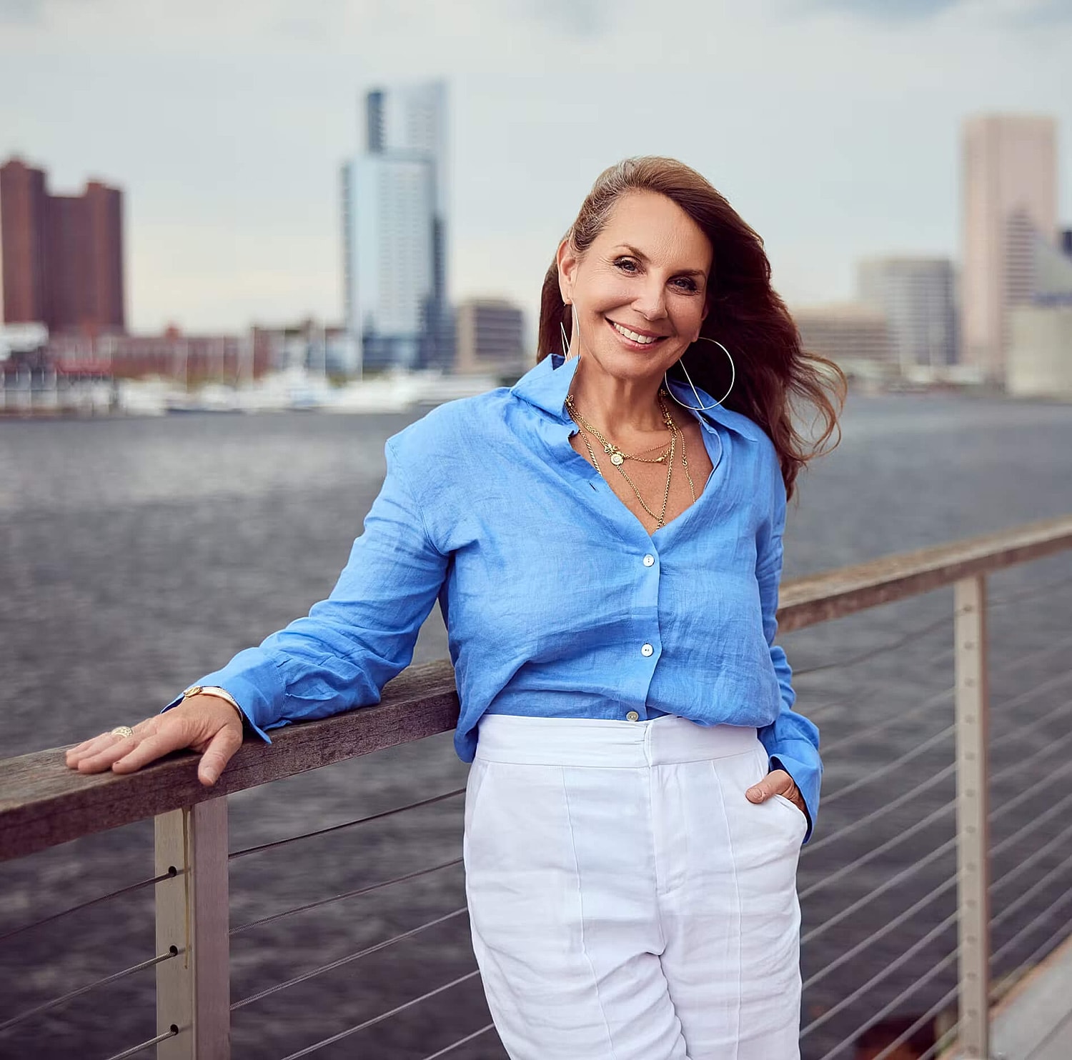 Model posing in a casual white outfit.